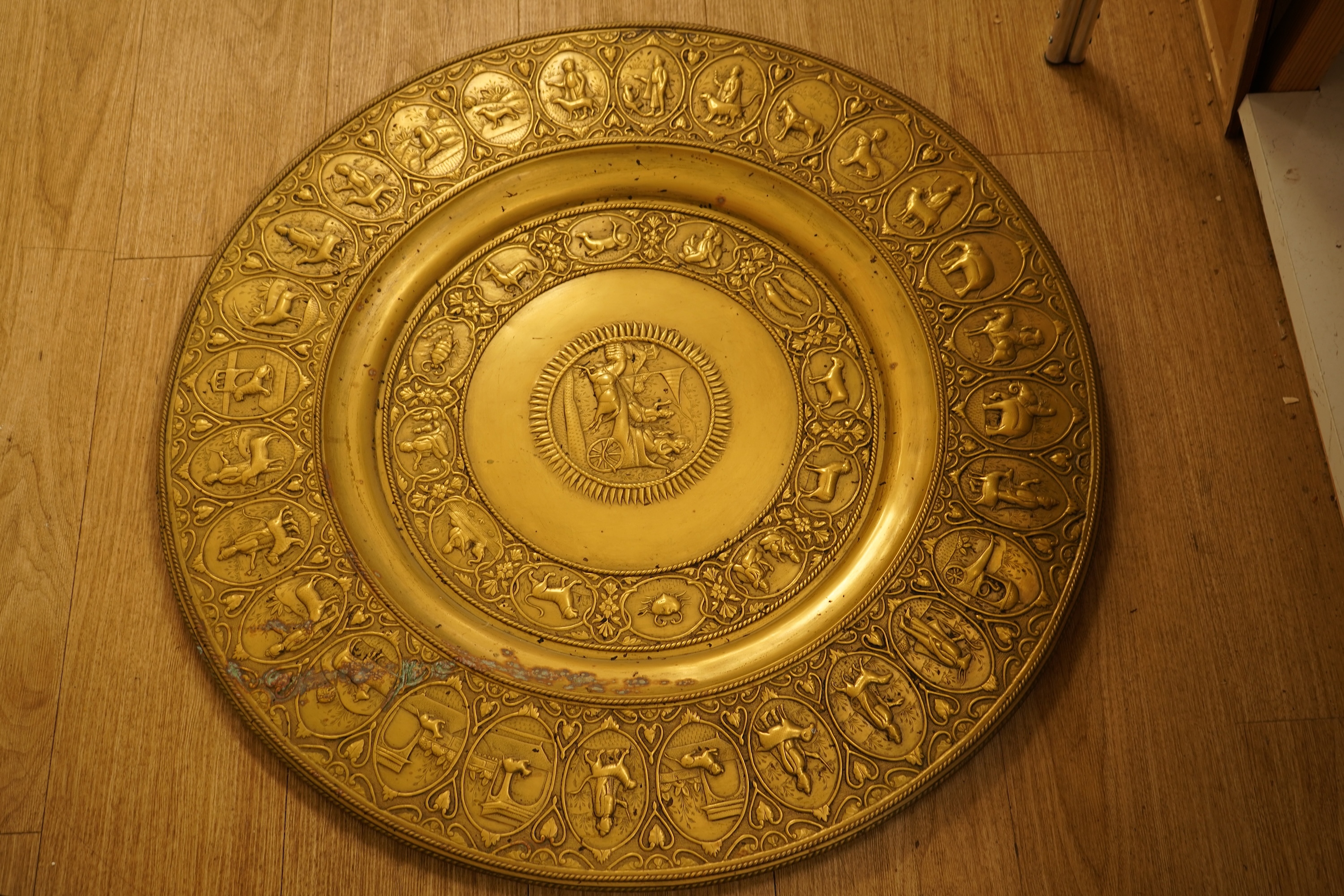 A large early 20th century Indian embossed brass tray, 78cm in diameter